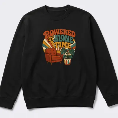 Retro design featuring an armchair and potted plant with the text 'Powered By Alone Time' — printed on a unisex sweatshirt