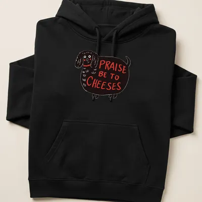 Whimsical illustration of a black dog with the text 'Praise Be To Cheeses' — printed on a unisex hoodie