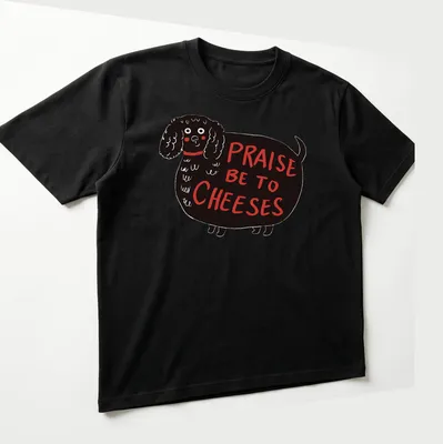 Whimsical illustration of a black dog with the text 'Praise Be To Cheeses' — printed on a unisex t-shirt (angled view)
