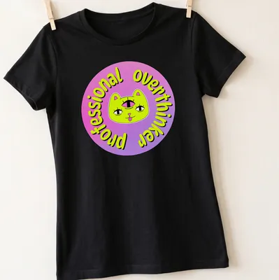 Colorful cartoon cat with a third eye and the text 'Professional Overthinker' — printed on a women's shirt