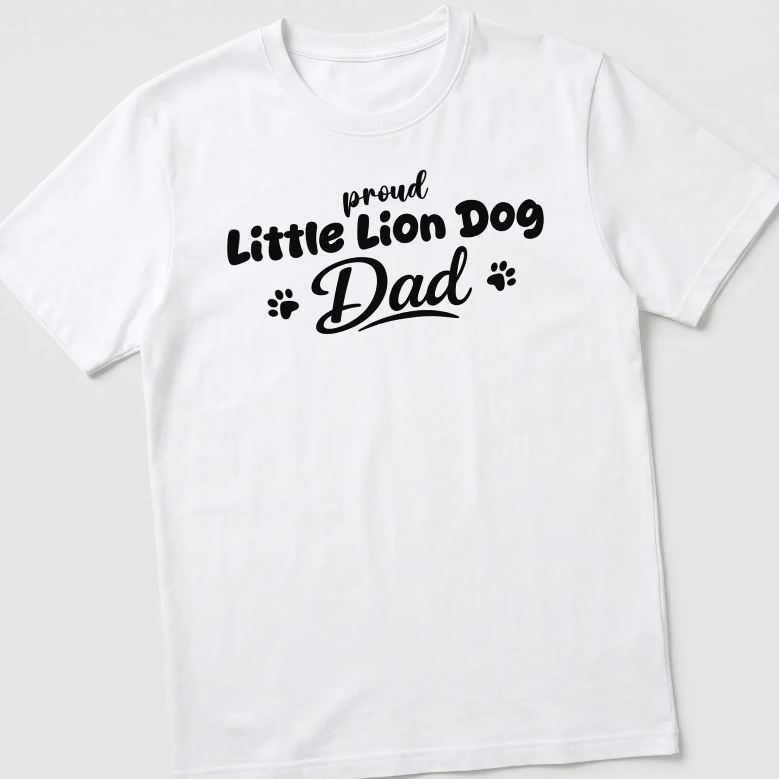 Illustration of a Little Lion Dog with bold text above saying Proud Little Lion Dog Dad — printed on a unisex t-shirt