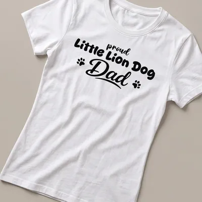 Illustration of a Little Lion Dog with bold text above saying Proud Little Lion Dog Dad — printed on a women's shirt
