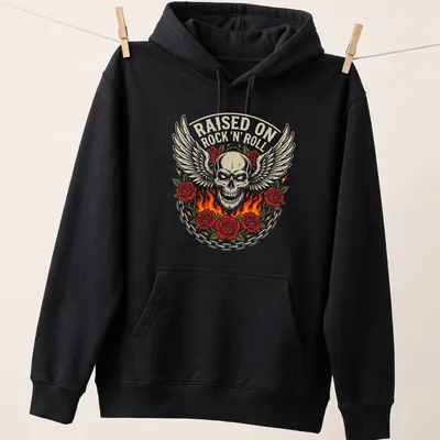 Bold vintage graphic of a winged skull entwined with roses and text RAISED ON ROCK 'N' ROLL — printed on a unisex hoodie