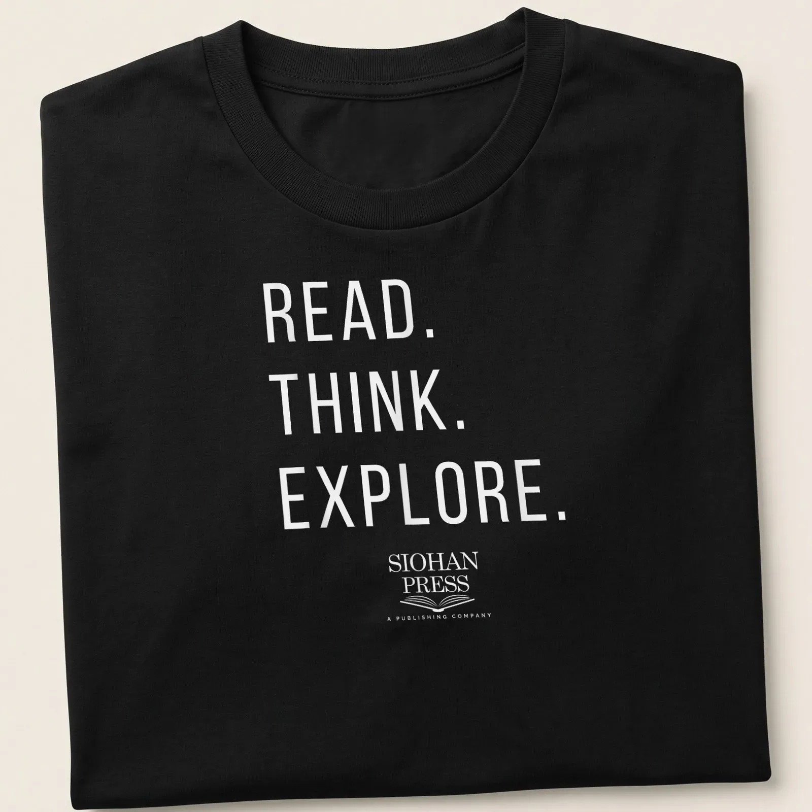 Minimalist white t-shirt with the text 'Read. Think. Explore. Siohan Press A Publishing Company' — printed on a unisex t-shirt