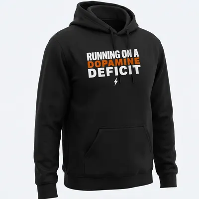 Bold typography humor t-shirt with the phrase 'RUNNING ON A DOPAMINE DEFICIT' in orange and white. — printed on a unisex hoodie