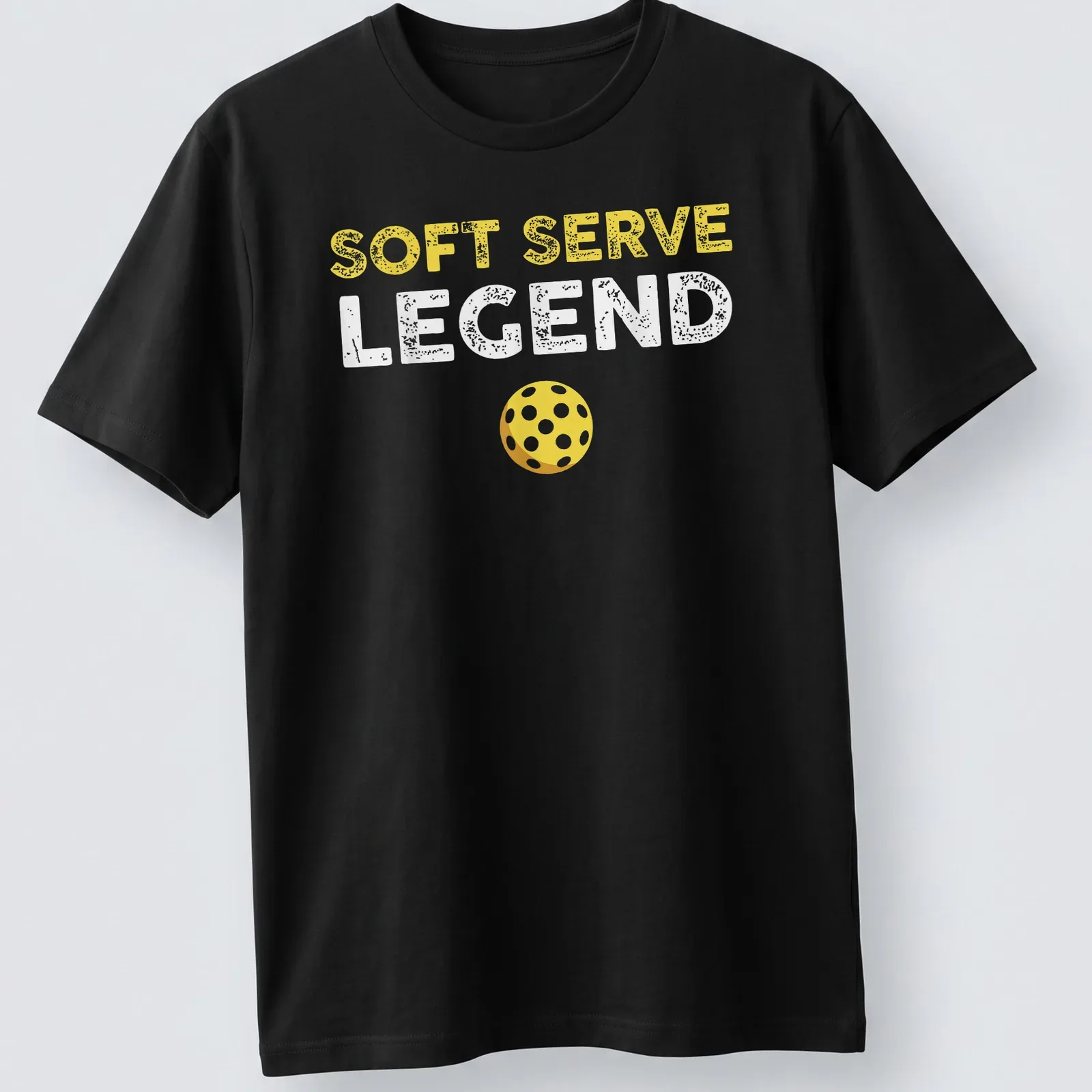 Distressed retro design featuring 'Soft Serve Legend' with a yellow pickleball. — printed on a unisex t-shirt