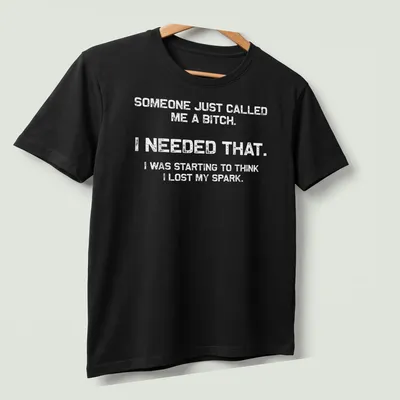 Bold motivational phrase t-shirt with distressed typography in black and white — printed on a unisex t-shirt (angled view)