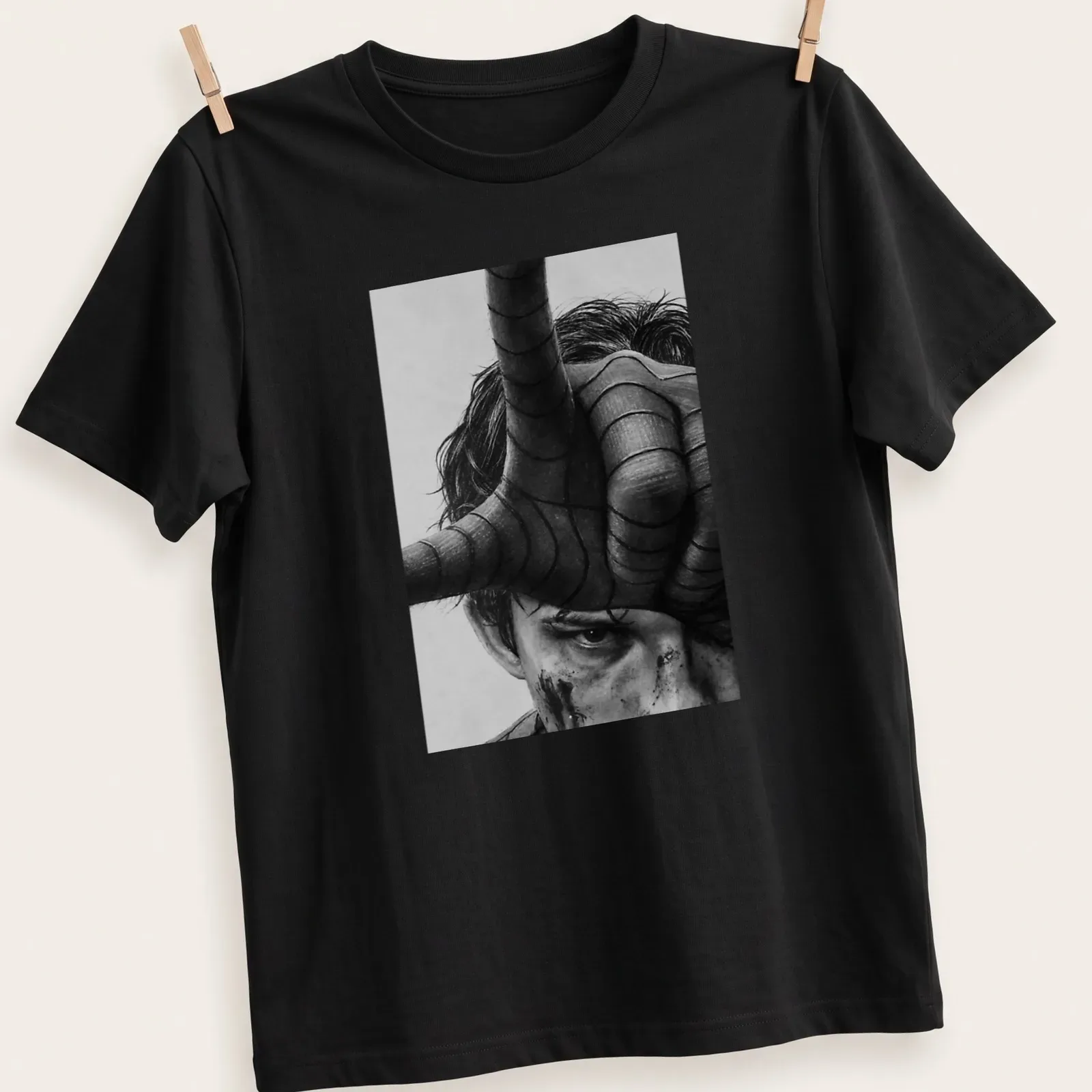 Realistic portrait of Tom Holland as Spider Man in black, white, and gray — printed on a unisex t-shirt