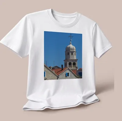 Photographic print of St Helen's Church Tower with blue sky and architectural details — printed on a unisex t-shirt (angled view)