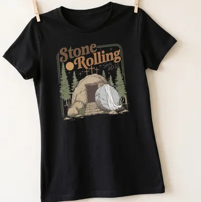 Vintage illustration of an empty tomb with a rolled stone and crosses, featuring the text Stone Rolling Since AD 33 — printed on a women's shirt