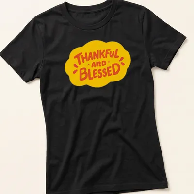 Playful cartoon design featuring a cloud and the words Thankful and Blessed — printed on a women's shirt
