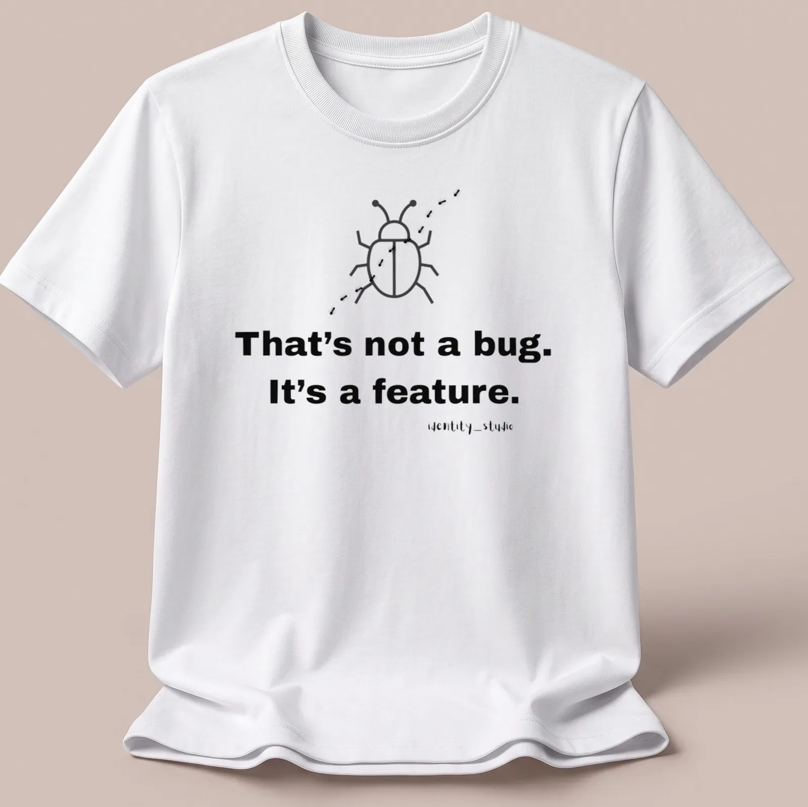 Simple line-art beetle with text 'That's not a bug. It's a feature.' — printed on a unisex t-shirt