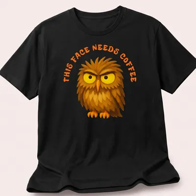 Cartoon grumpy owl with text 'This Face Needs Coffee' in brown, yellow, and orange — printed on a unisex t-shirt