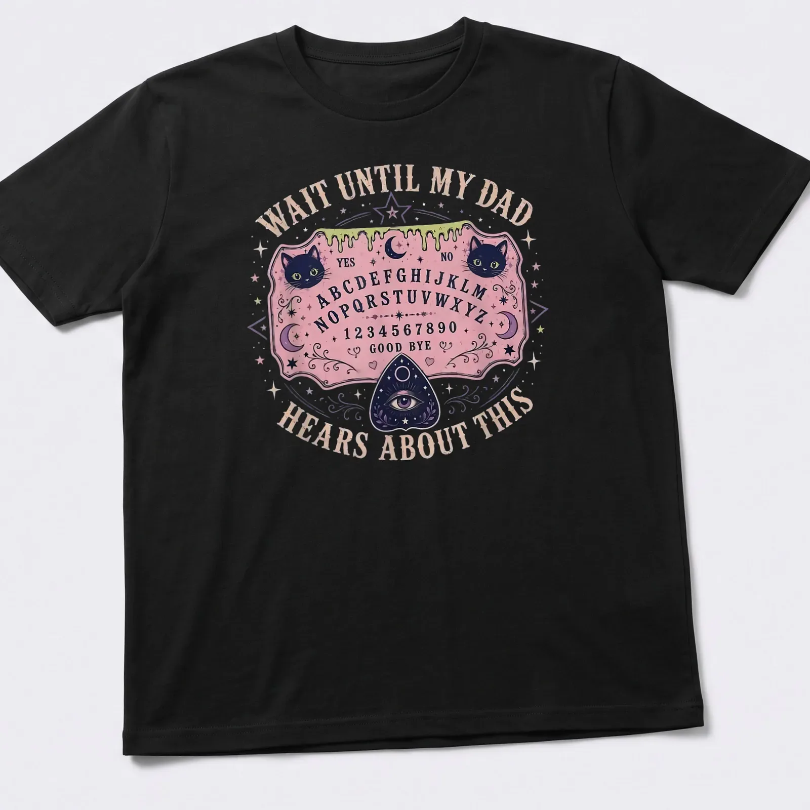 Whimsical T-shirt design featuring Ouija board and playful cats with humorous text. — printed on a unisex t-shirt
