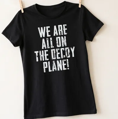 Vintage design featuring a humorous decoy plane graphic with bold text — printed on a women's shirt