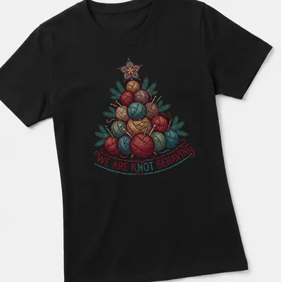 Illustrated yarn Christmas tree with the text 'We Are Knot Behaving' in festive colors — printed on a women's shirt