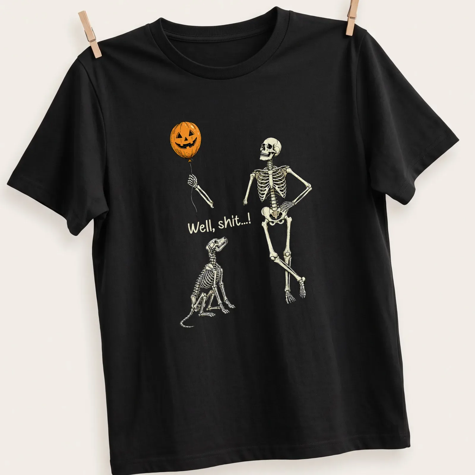 Whimsical skeleton with pumpkin balloon and dog design on — printed on a unisex t-shirt