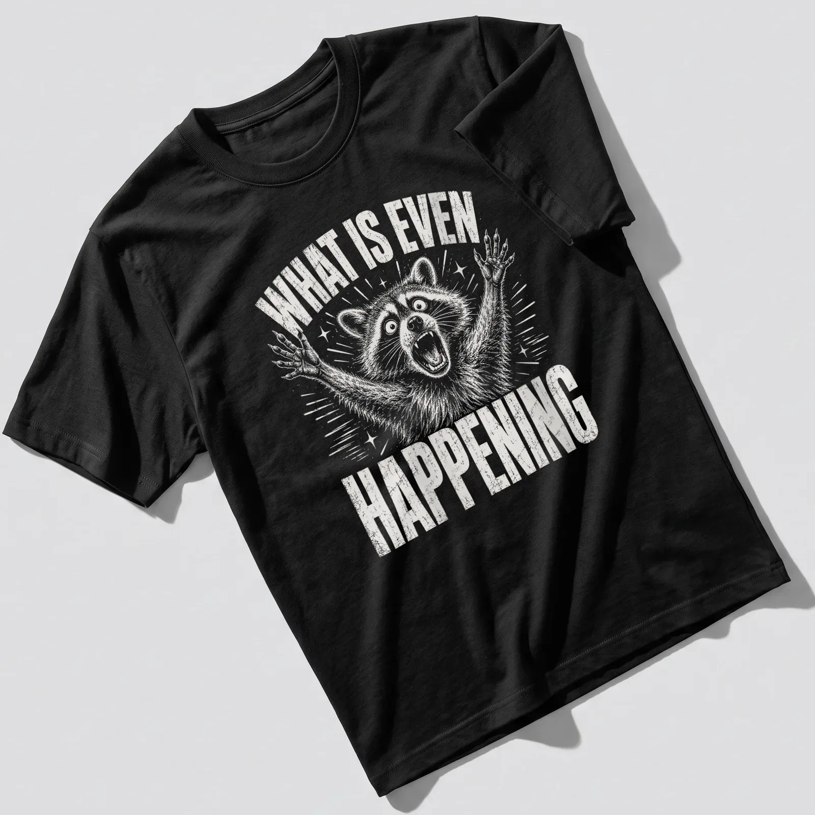 Vintage distressed t-shirt featuring a confused raccoon with the text 'WHAT IS EVEN HAPPENING' — printed on a unisex t-shirt