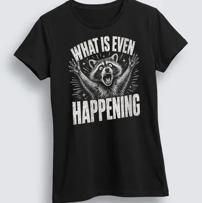Vintage distressed t-shirt featuring a confused raccoon with the text 'WHAT IS EVEN HAPPENING' — printed on a women's shirt