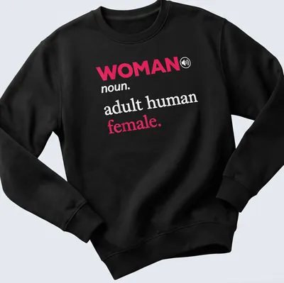 Modern typography t-shirt with the text 'WOMAN noun. adult human female.' in pink and white. — printed on a unisex sweatshirt