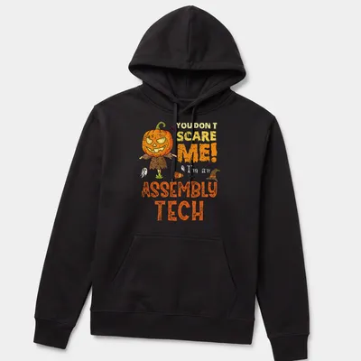 Funny Halloween shirt with cartoon pumpkin scarecrow and playful text — printed on a unisex hoodie